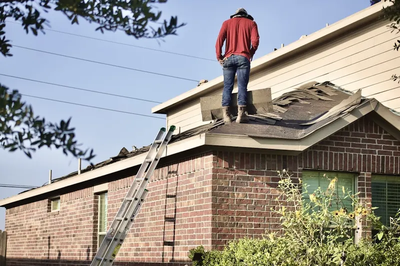 Professional roofer working on a residential roof in Downtown